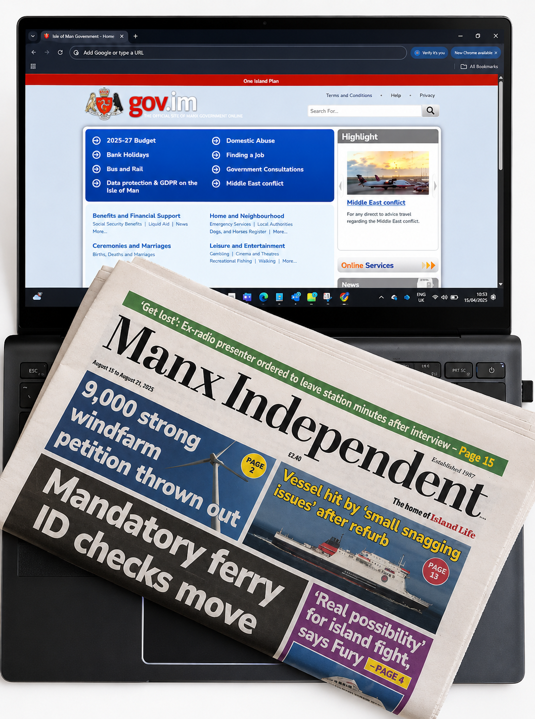 A laptop showing the Isle of Man Government website with a Manx Independent newspaper resting on the keyboard